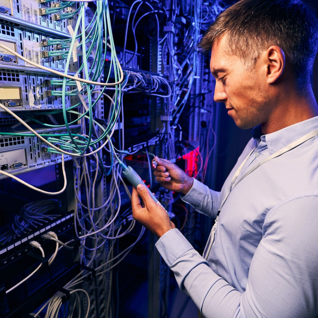 Network technician working on a managed network rack